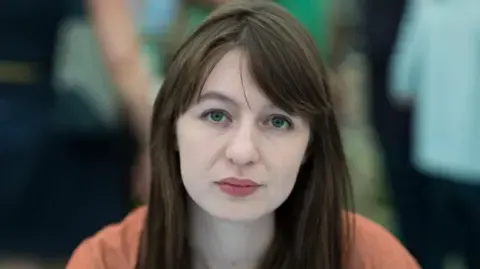 Irish author Sally Rooney states she is unable to visit the UK because of potential arrest